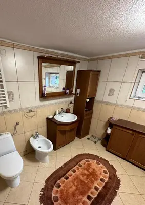 a bathroom with a sink and a toilet and a sink at Apartament u Moni in Sucha Beskidzka
