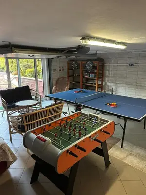 a living room with a table and a pool table at Apartament u Moni in Sucha Beskidzka
