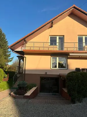 a large house with a balcony on top of it at Apartament u Moni in Sucha Beskidzka