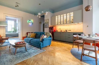 a living room with a blue couch and a table at Two bedroom apartment-Dietla 11- Wawel Castle view in Kraków