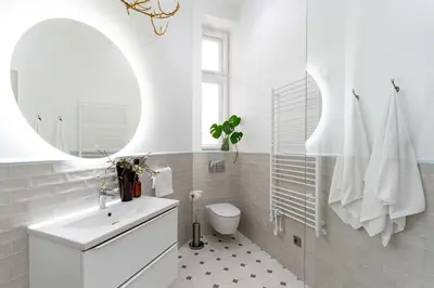 a bathroom with a sink and a toilet and a mirror at Two bedroom apartment-Dietla 11- Wawel Castle view in Kraków
