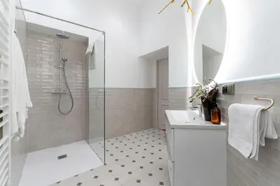 a white bathroom with a shower and a sink at Two bedroom apartment-Dietla 11- Wawel Castle view in Kraków
