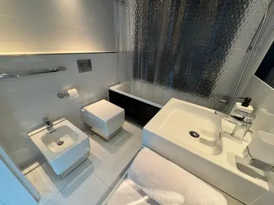 a white bathroom with a sink and a toilet at Black&White Angel Apartment in Kraków