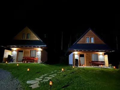 a house with candles in the yard at night at Leśne Zacisze in Ochotnica Górna