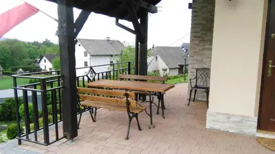 a wooden table and bench on a balcony at Morycówka in Rzyki