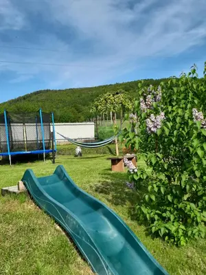 a playground with a slide in a yard at Morycówka in Rzyki
