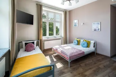 a bedroom with two beds and a window at Wavelo Apartments in Kraków