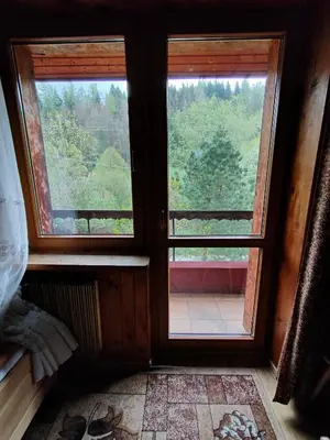 a room with a door and two windows with a view at Chata Pod Kwiatkiem in Zawoja