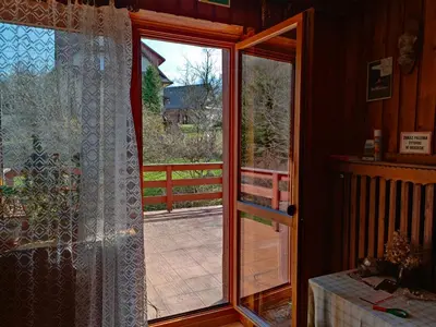 a door to a porch with a view of a yard at Chata Pod Kwiatkiem in Zawoja