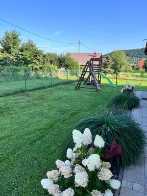a playground with a slide in a yard at Dom w Beskidach in Zagórnik
