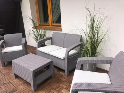 a group of chairs and tables on a patio at Dom w Beskidach in Zagórnik