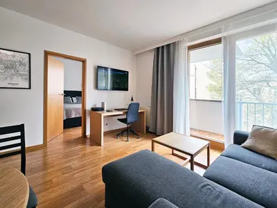 a living room with a couch and a desk at Old Town Plaza Apartment in Kraków