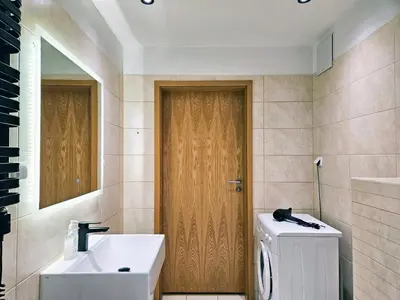 a bathroom with a toilet and a sink and a mirror at Old Town Plaza Apartment in Kraków