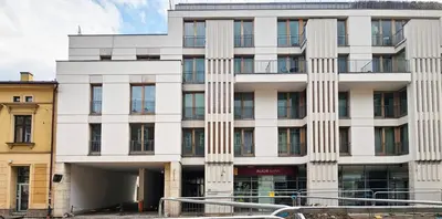 a white building with a lot of windows at Old Town Plaza Apartment in Kraków