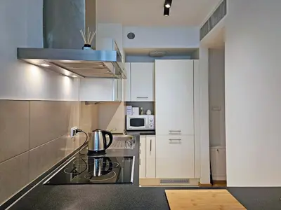 a kitchen with a coffee maker on a stove at Old Town Plaza Apartment in Kraków
