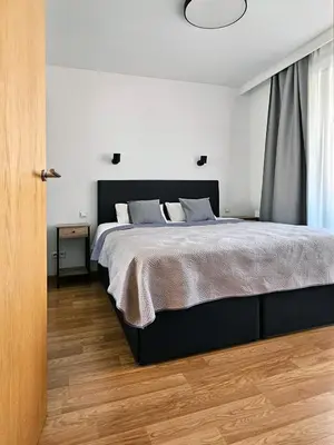 a bedroom with a large bed and a window at Old Town Plaza Apartment in Kraków