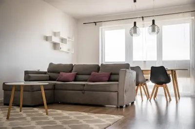 a living room with a couch and a table at Tauron Arena Residence WAWELOFTS in Kraków