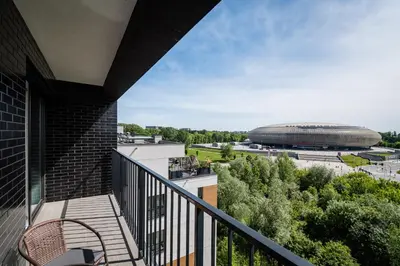 a balcony with a view of a football stadium at Tauron Arena Residence WAWELOFTS in Kraków