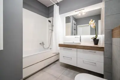 a bathroom with a sink and a tub and a toilet at Tauron Arena Residence WAWELOFTS in Kraków