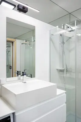 a white bathroom with a sink and a mirror at Kraków Kazimierz Charm - by Upstairs in Kraków