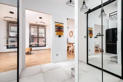 a room with glass doors and a dining room at Kraków Kazimierz Charm - by Upstairs in Kraków