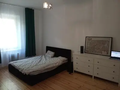 a bedroom with a bed and a dresser and a window at Apartament Central Station Batorego in Kraków