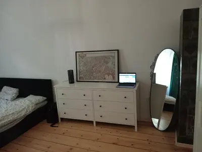 a bedroom with a bed and a dresser with a mirror at Apartament Central Station Batorego in Kraków