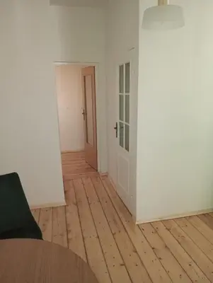 an empty room with a table and a door at Apartament Central Station Batorego in Kraków