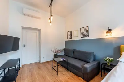 a living room with a couch and a table at St Florian Apartments in Kraków