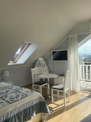 a bedroom with a bed with a flowery wallpaper at Noclegi Bajama in Siepraw