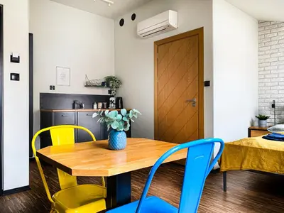 a dining room with a wooden table and chairs at Cozy apartment with AC for couples - Old Town in Kraków