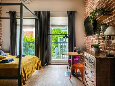 a bedroom with a bed and a table and a window at Cozy apartment with AC for couples - Old Town in Kraków