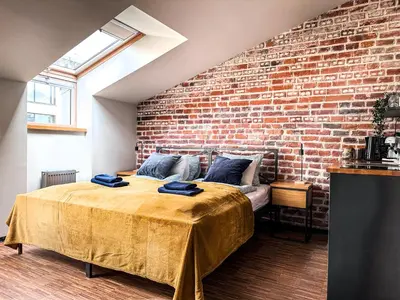 a bedroom with a brick wall and a bed at Cozy apartment with AC for couples - Old Town in Kraków