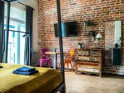 a bedroom with a brick wall and a bed at Cozy apartment with AC for couples - Old Town in Kraków