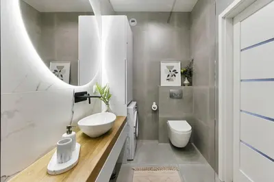 a bathroom with a sink and a toilet and a mirror at Cracow Palm Apartment in Kraków