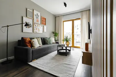 a living room with a couch and a table at Cracow Palm Apartment in Kraków