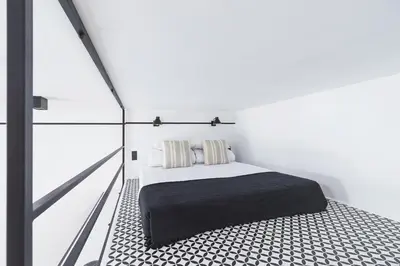 a bedroom with a bed and a glass wall at Main Station - Radziwiłłowska 27 in Kraków
