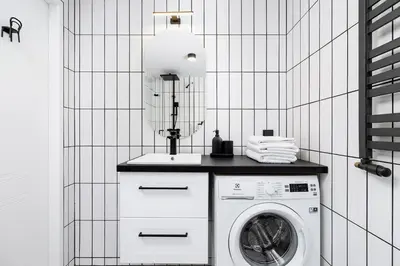 a laundry room with a washing machine and a sink at Main Station - Radziwiłłowska 27 in Kraków