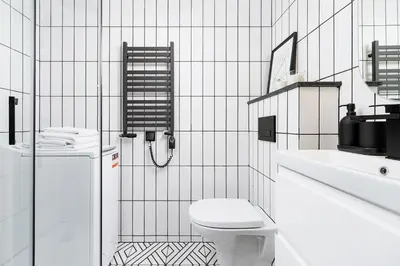 a white bathroom with a toilet and a sink at Studio apartment - Radziwiłłowska 27 in Kraków