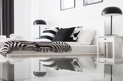 a white bedroom with a bed with black and white pillows at Krakowska 16 Street Kazimierz District in Kraków