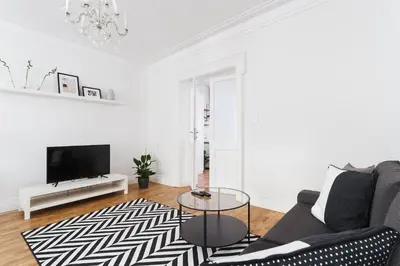 a living room with a couch and a tv at Krakowska 16 Street Kazimierz District in Kraków