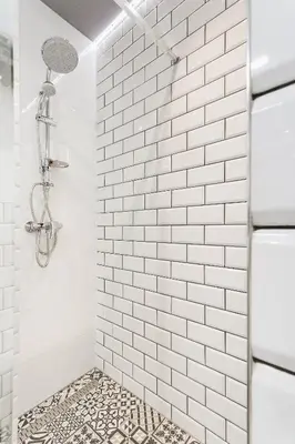 a white tiled shower with a glass door at Krakowska 16 Street Kazimierz District in Kraków