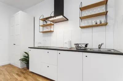 a kitchen with white cabinets and a sink at Krakowska 16 Street Kazimierz District in Kraków