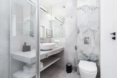 a white bathroom with a sink and a toilet at Studio with a balcony and AC - Rajska 3 street in Kraków