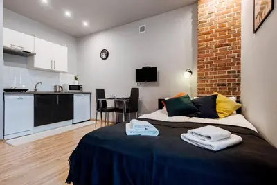 a bedroom with a bed with towels on it at Studio with balcony - Rzeszowska 4 Street in Kraków