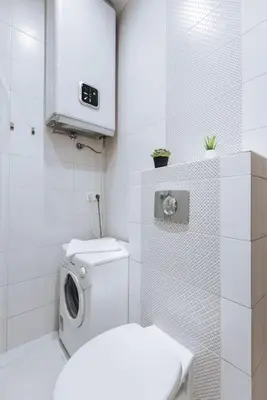 a white bathroom with a toilet and a sink at Studio with balcony - Rzeszowska 4 Street in Kraków