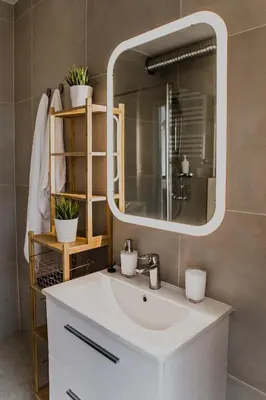a bathroom with a white sink and a mirror at 1 - bedroom Apartment - Przemyska 4 Street in Kraków