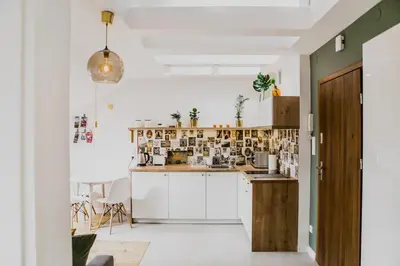 a kitchen with white cabinets and a counter top at 1 - bedroom Apartment - Przemyska 4 Street in Kraków