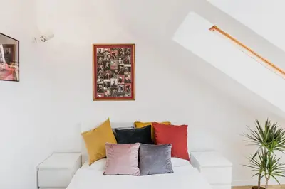 a white couch with colorful pillows on it at 1 - bedroom Apartment - Przemyska 4 Street in Kraków