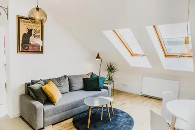 a living room with a couch and a table at 1 - bedroom Apartment - Przemyska 4 Street in Kraków